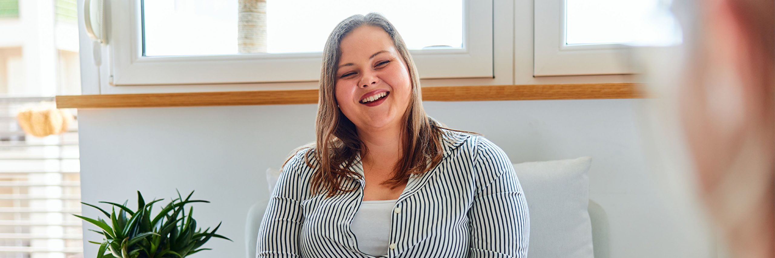 Smiling woman in a bright room
